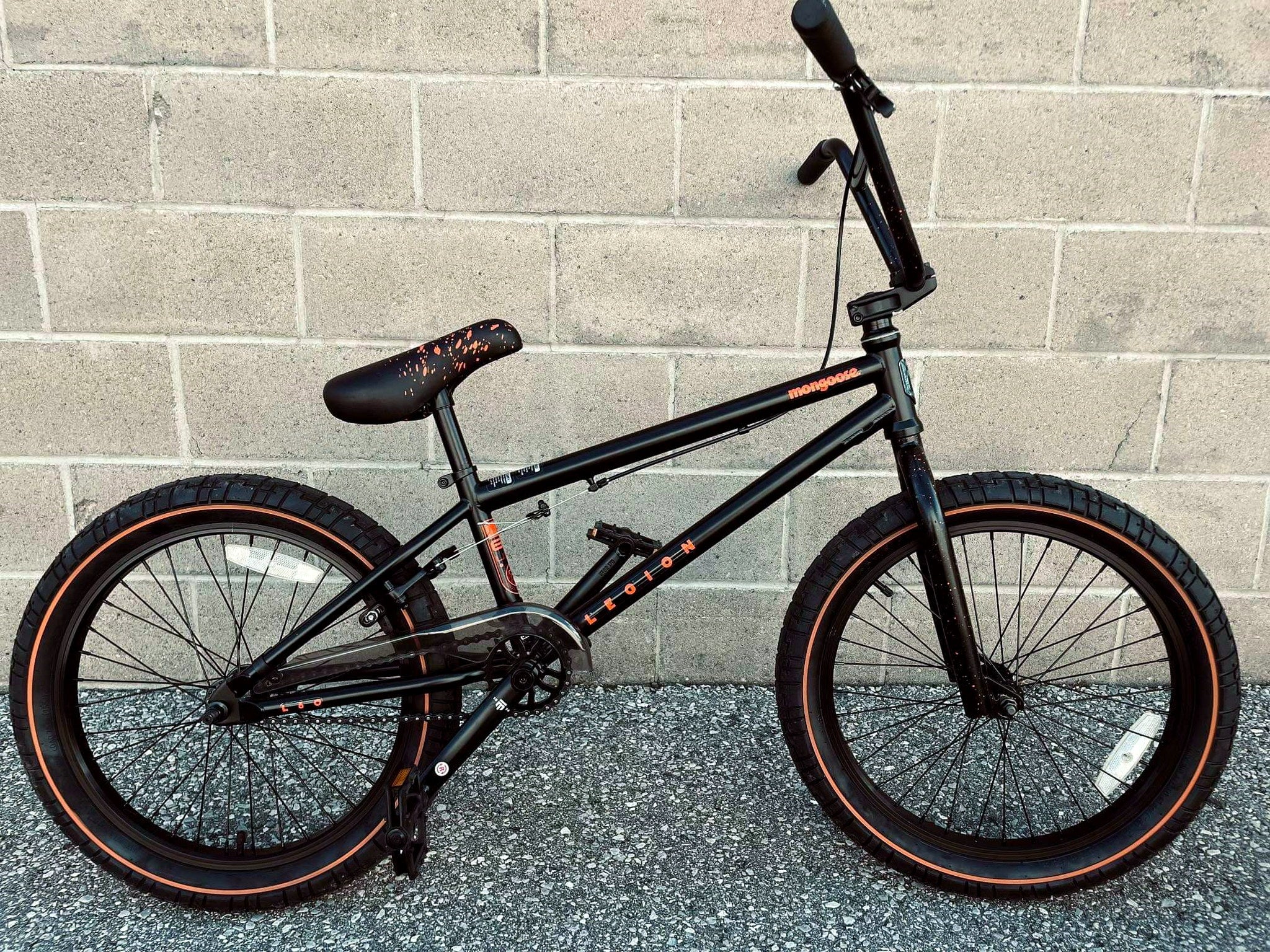 Mongoose Legion L60 BMX bike with 20-inch wheels, full side view showing black frame, handlebars, and BMX components.