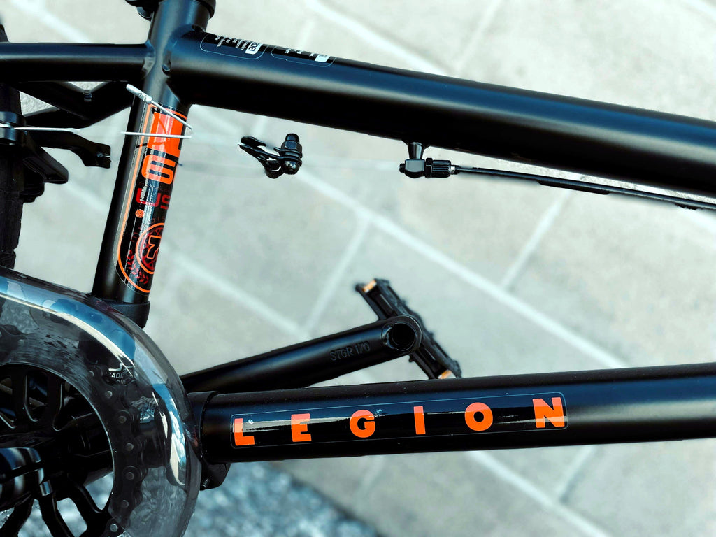 Close-up of Mongoose Legion L60 BMX bike frame with logo and detailed craftsmanship, showcasing the freestyle 20-inch BMX design.