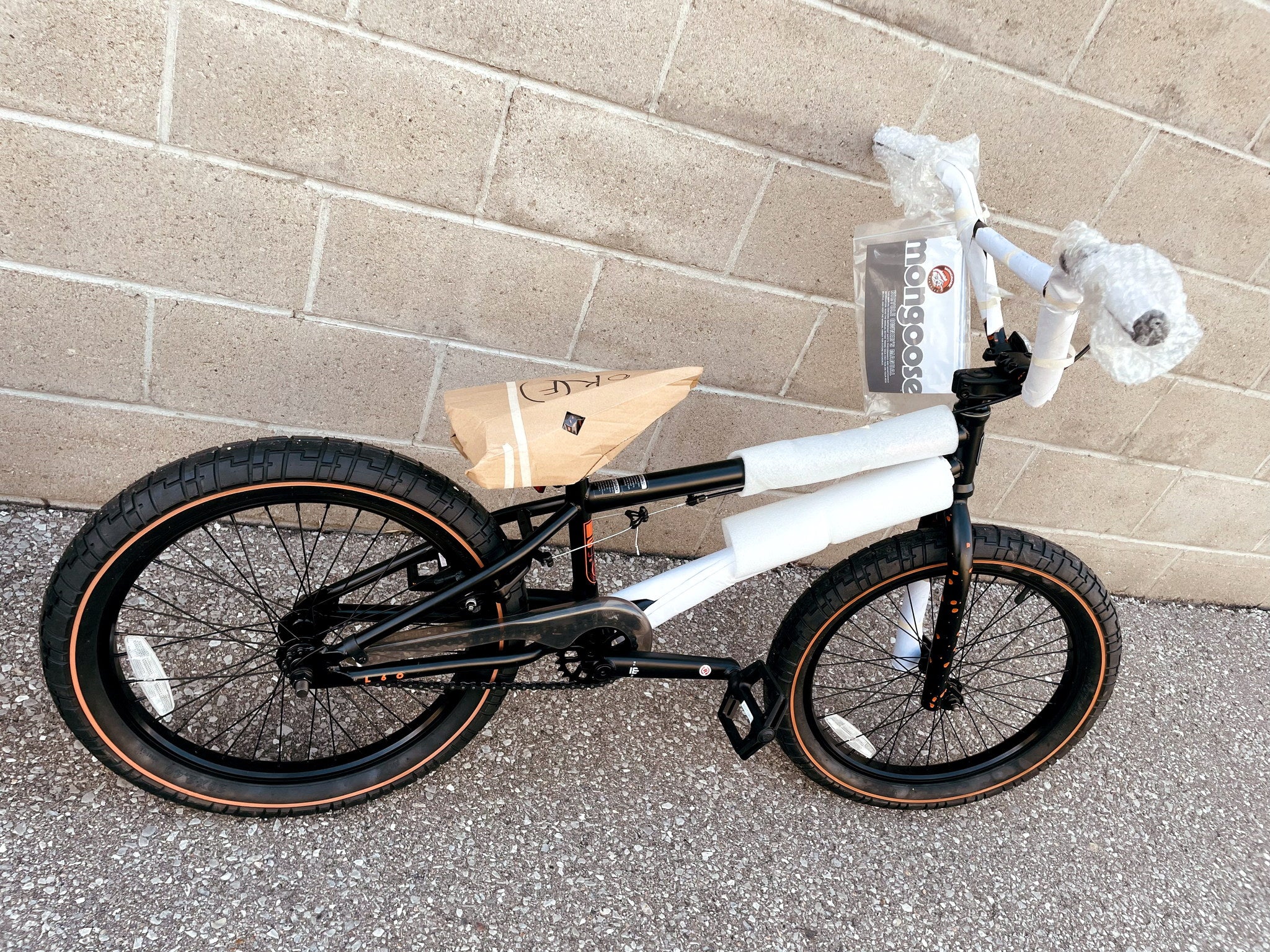 Mongoose Legion L60 BMX bike with a 20-inch frame, shown factory-packed before assembly, ready for freestyle riding.